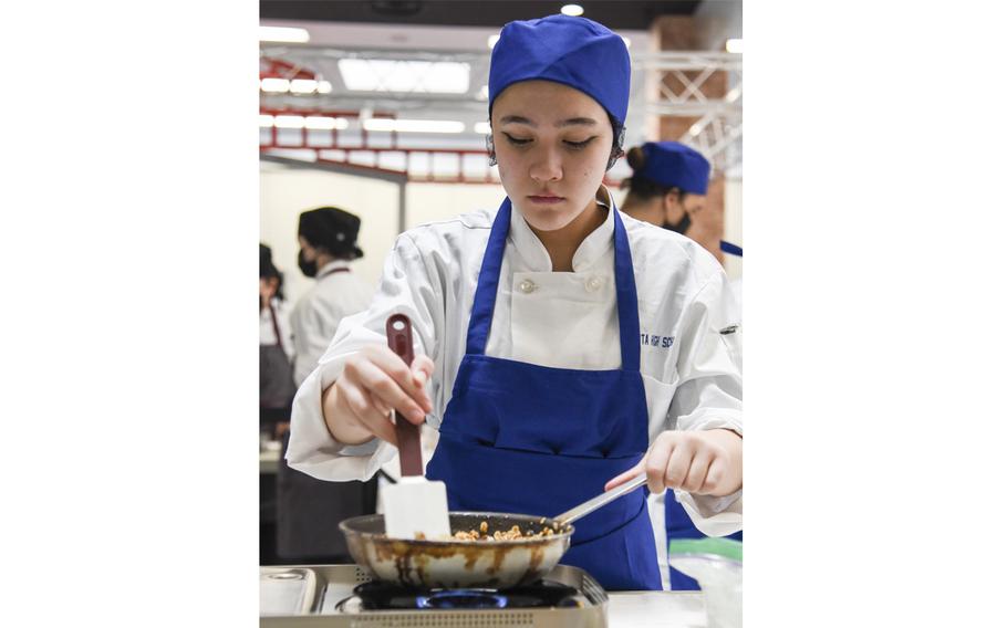 Yokota High School student Sophia Lopez prepares apple crisp during the Far East Culinary Arts Competition at Yokota Air Base, Japan, Feb. 7, 2023.