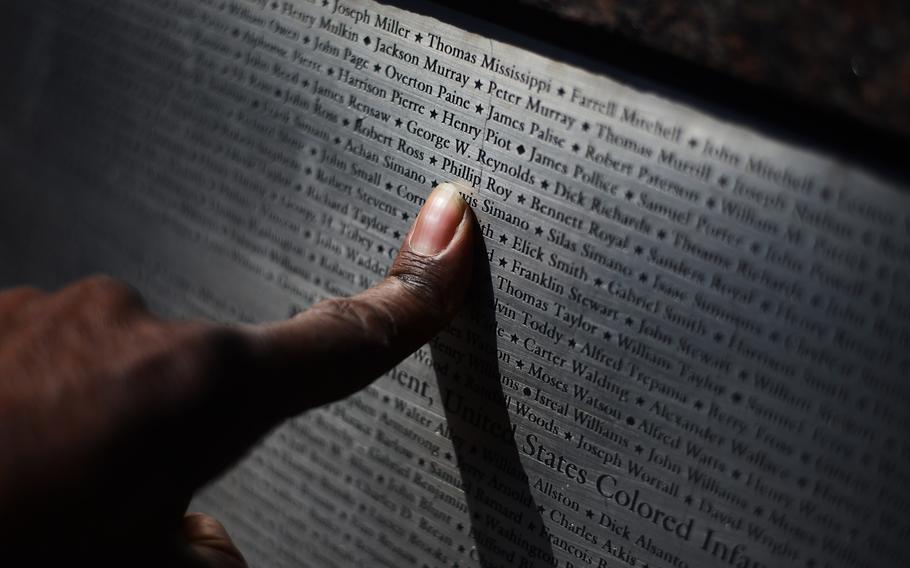 Photographer Roy Lewis points to the name of his great-great grandfather, Phillip Roy, who served in the infantry during the Civil War and whose name is engraved at the African American Civil War Memorial. 