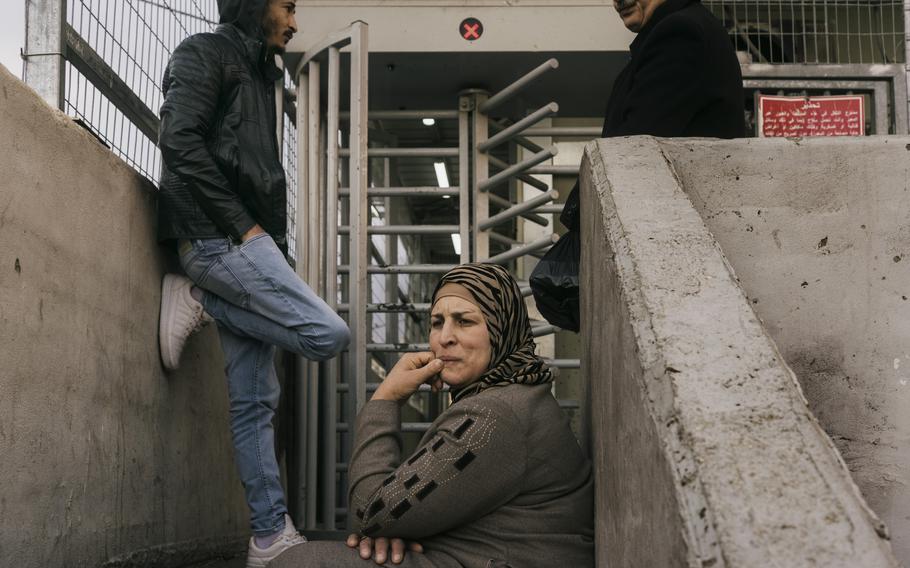 Ahlam Rajabi waits for her son to be released at a checkpoint in Hebron.  