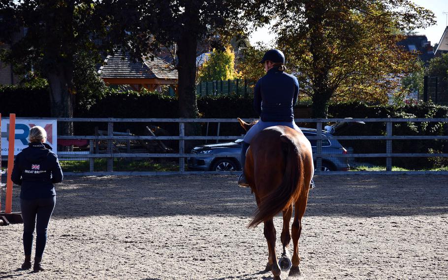 A trainer and rider discuss their routine in the riding arena of the museum’s Rothschild Yard on Oct. 11, 2022. The National Horse Racing Museum works with an organization that trains retired racehorses to adjust to a new life after their racing career. 