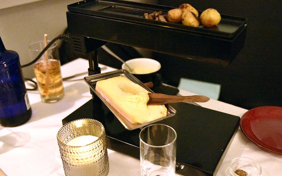 The Walliser raclette at Wallis 46 gives customers a do-it-yourself grill. The tray with the block of cheese, middle, goes below, while the vegetables sit on top. Once the cheese is melted, customers scrape off the top onto a plate, where the vegetables and seasonings are.