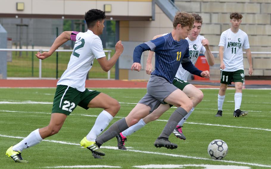 Ansbach’s Benjamin Schuck drives the ball up the field against AFNORTH’s Ronnie Macauley, left, and Andre Sperber, in a Division III semifinal at the DODEA-Europe soccer championships in Kaiserslautern, Germany, May 17, 2023. Ansbach beat AFNORTH 5-3 and will face Sigonella in Thursday’s final in Ramstein. 