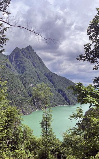 Along the incline on the Lake Mis-Val Falcina trail, there are benches and spots to stop for photos over the lake. The trail is in Italy's Dolomiti Bellunesi National Park. 