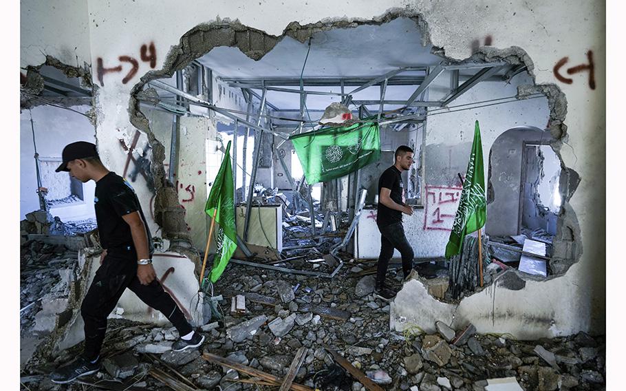 Palestinians inspect the ruins of the home of a Hamas militant that was demolished by Israeli troops in the West Bank village of Naalin, Tuesday, May 23, 2023. 