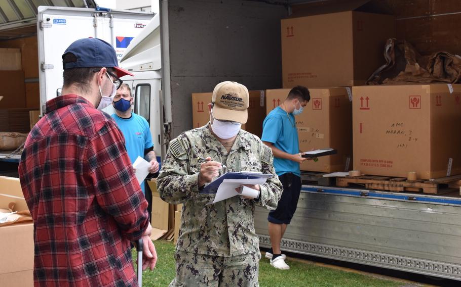 The team from Naval Supply Systems Command, Fleet Logistics Center, assists an unaccompanied sailor with his household goods at Yokosuka Naval Base, Japan, June 2, 2020. 