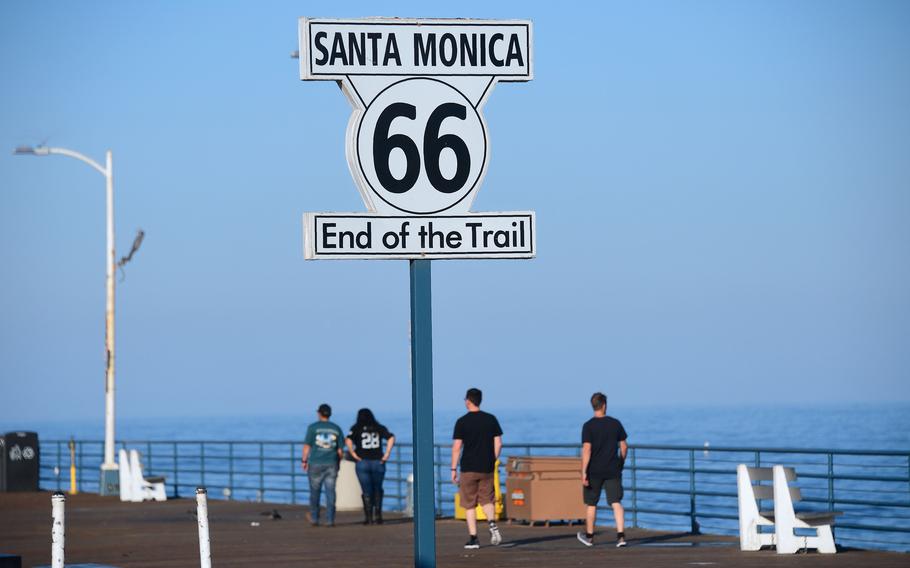 People walk past the “End of the Trail” for Route 66 sign at Santa Monica pier in Santa Monica, Calif., on May 21, 2017. For decades, Route 66 captured the imagination of travelers the world over, offering a glimpse of a bygone era of American history, when people hit the road in search of adventure and a better life. The two-lane highway established in 1926 and coined the “Mother Road” by author John Steinbeck seemed to encompass the essence of America, threading through eight states from Chicago to Santa Monica. 