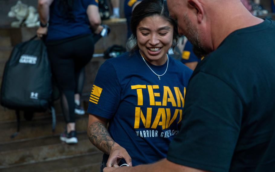 A Navy service member accepting her gear.