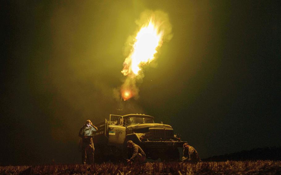 Flames emerge as Ukrainian soldiers fire at drones.