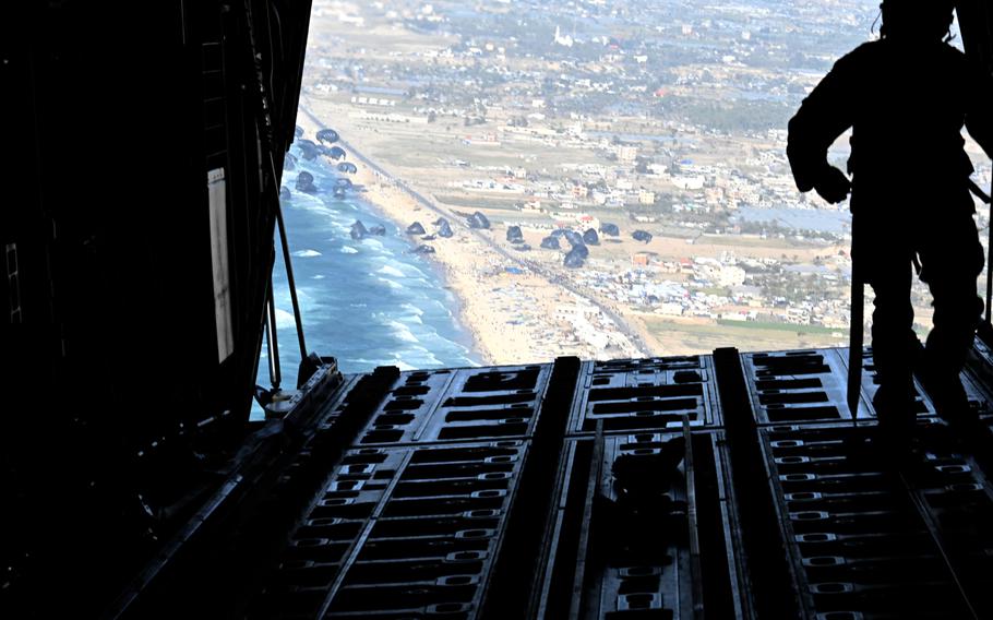 A U.S. Air Force loadmaster releases humanitarian aid pallets of food and water over Gaza, March 2, 2024. 