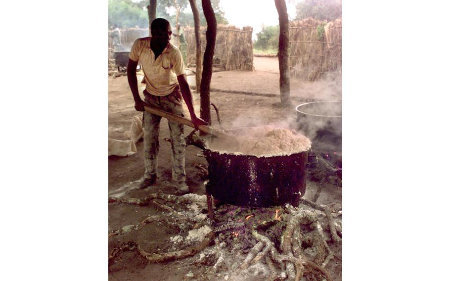  A Ugandan soldier stirs typical Ugandan army lunch, an oatmeal-like grain porridge. Along with military and peacekeeping tactics, U.S. soldiers trained the Ugandans in such areas as keeping field kitchens sanitary. 