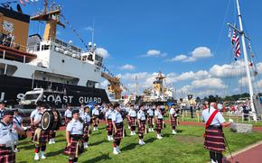 The U.S. Coast Guard Pipe Band plays Aug. 5, 2022, during the The National Memorial Service honoring fallen U.S. Coast Guard officers at the annual Grand Haven (Mich.) Coast Guard Festival.