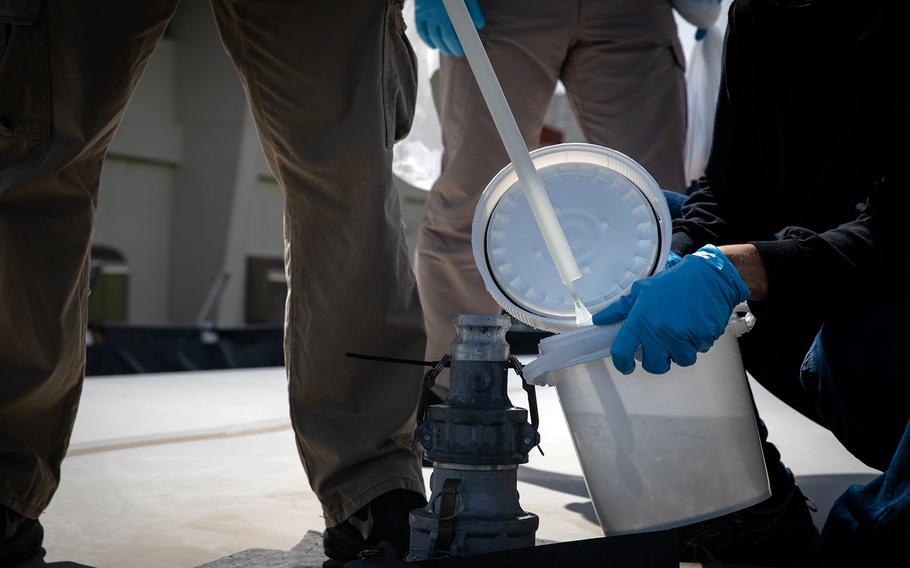 Japanese officials collected samples of treated wastewater at Marine Corps Air Station Futenma, Okinawa, Monday, July 19, 2021.