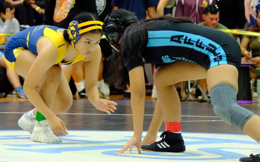 Guam High's Lauri Cavaco, left, finished second at 119 pounds in Saturday's All-Island wrestling finals.