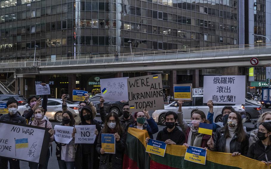 Protesters display placards in front of the Representative Office of the Moscow-Taipei Coordination Commission to protest against Russia’s military invasion of Ukraine on Feb. 25, 2022, in Taipei, Taiwan.