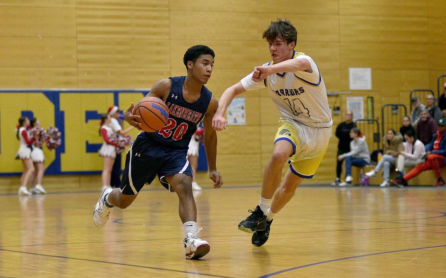 Lakenheath's Brian Mills dribbles as Hayden Tallant defends during a Dec. 1, 2023, game at Wiesbaden High School in Wiesbaden, Germany.