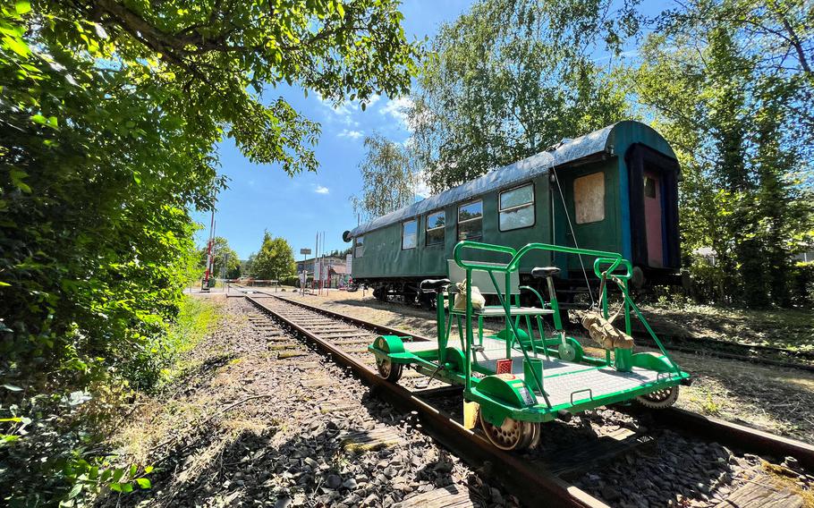 A draisine sits next to an abandoned railroad car in Bedesbach, Germany. Various villages along the Glan Valley line offer opportunities for detours to small valley churches, a historic blacksmith workshop and other rural attractions.