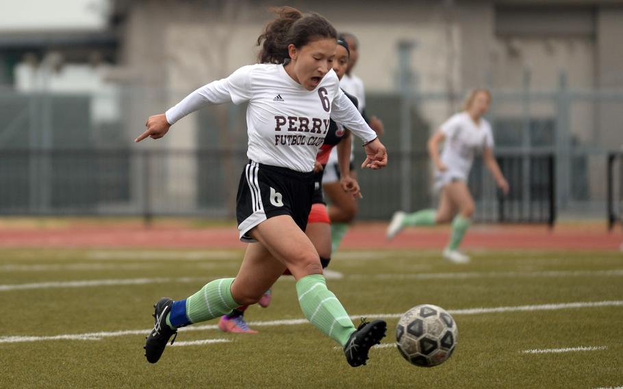 Matthew C. Perry's Sasha Malone dribbles the ball upfield against E.J. King during Friday's DODEA-Japan girls soccer match. The Cobras won 3-0.