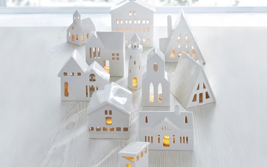 This image shows Crate & Barrel’s collection of white ceramic buildings. Add a tealight for a welcoming glow. 