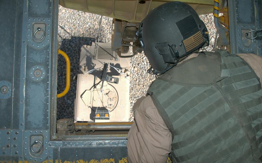 Flight engineer Staff Sgt. Robert Kilcup watches as a Humvee, slung below his CH-47 helicopter, is lowered to the ground near a firebase at Deh Rawood, Afghanistan. Kilcup and the five-man crew of Chief Warrant Officer 3 Larry Murphy, Capt. Robert Dietrick, Sgt. Nick Robitaille and Staff Sgt. Joey Barnard flew the Humvee and some soldiers to the base, then flew a group of Afghan National Army back to their home base of Kandahar.  