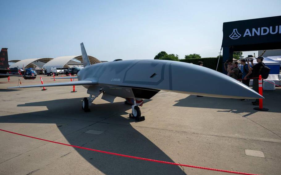 A sleek aircraft rests on asphalt on a sunny day.