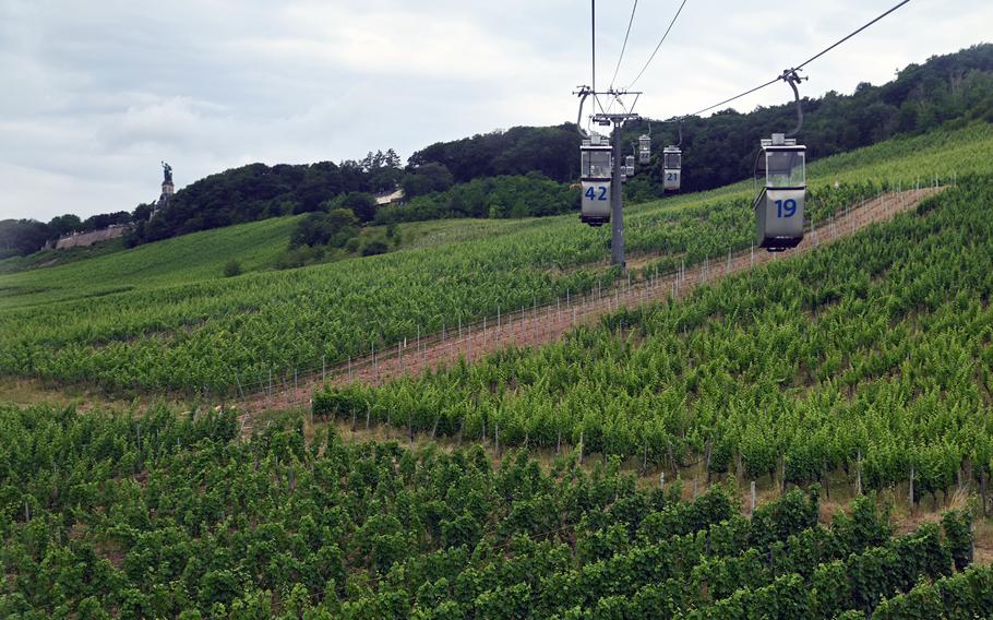 Gondolas glide over the vineyards of Germany's Rheingau region between Ruedesheim and the Niederwald Monument, which can be seen in the distance at left.