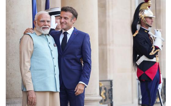 Emmanuel Macron greets Indian Prime Minister Narendra Modi at Élysée Palace in Paris in July. MUST CREDIT: Bloomberg photo by Nathan Laine