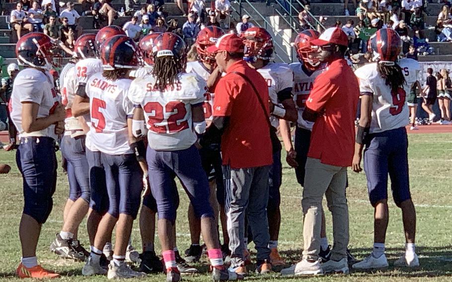 The Aviano coaching staff works to motivate the Saints during Saturday’s championship game against Naples.