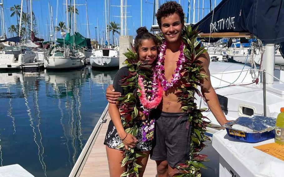 Tyler Savage and Bella Siegrist pose at Ala Wai Boat Harbor, Honolulu, June 5, 2021, just after completing a three-week sailboat trip from San Diego.