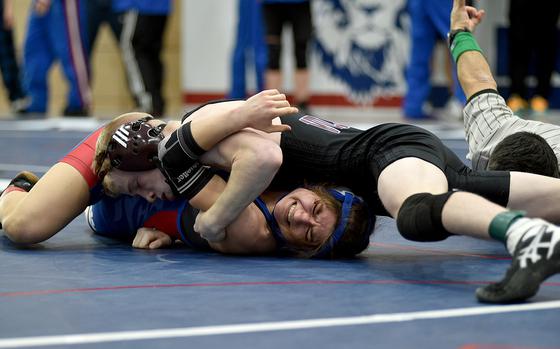 Vilseck's Christopher Wissemann tries to pin Ramstein's Liberty Snyder during the third-place match for 113 pounds at the DODEA Central sectional wrestling tournament on Saturday at Ramstein High School on Ramstein Air Base, Germany.