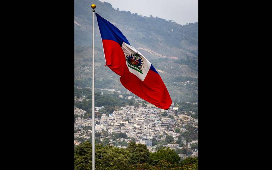 The Haitian flag waves over the Champ de Mars in Port-au-Prince, Haiti, in June 2022. Sidewalk vendors have become sparse because of kidnapping gangs.