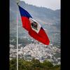 The Haitian flag waves over the Champ de Mars in Port-au-Prince, Haiti, in June 2022. Sidewalk vendors have become sparse because of kidnapping gangs. (Jose A. Iglesias/Miami Herald/TNS)