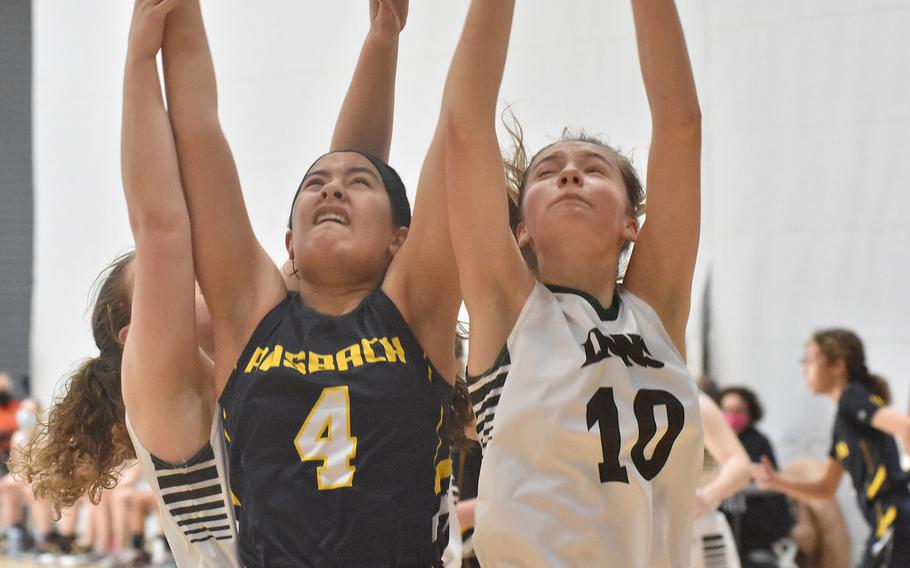 Ansbach's Tessa Stanley, left, and AFNORTH's Coral Moberg stretch as high as they possible can for a rebound in the Lions' 38-17 victory Wednesday, Feb. 23, 2022, at the opening day of the DODEA-Europe Division III basketball championships.