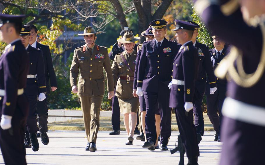 Lt.. Gen. Simon Stuart, Australian Army chief, alongside Gen. Yasunori Morishita, chief of staff for the Japan Ground Self-Defense Force, offer a flower wreath at Japan’s Ministry of Defense in Tokyo on Dec. 15.