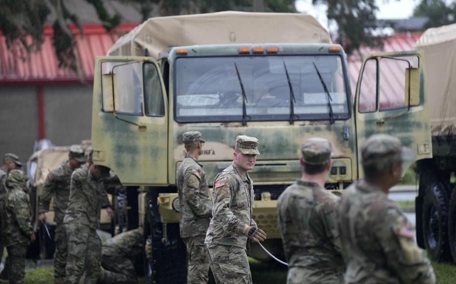 Members of the National Guard prepare their equipment in Mayo, Fla., as they wait for instructions on where to respond, after the passage of Hurricane Idalia, Wednesday, Aug. 30, 2023.