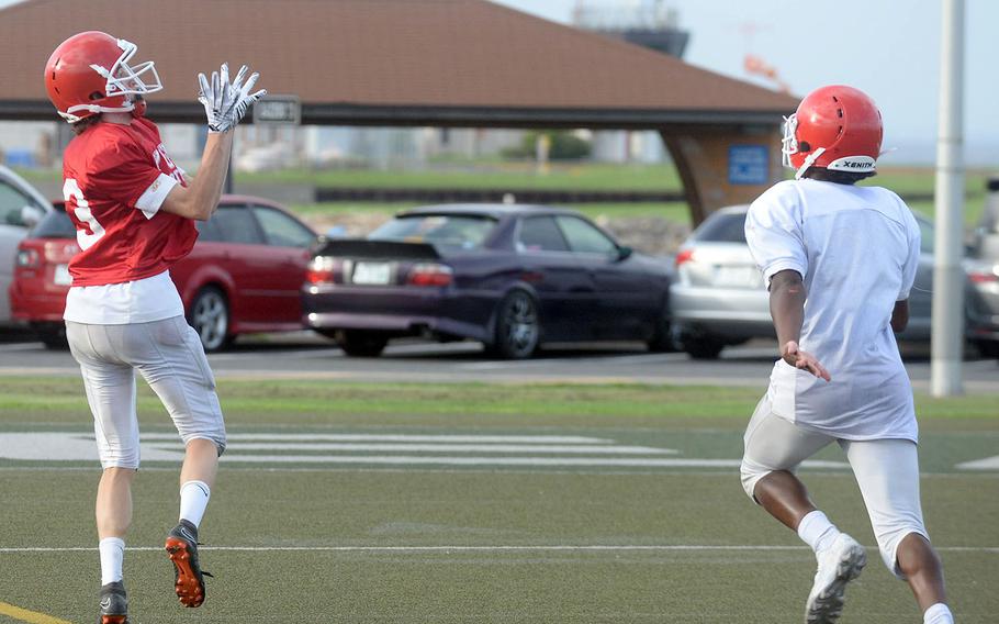 Nile C. Kinnick receiver Ryo Nishiyama hauls in a pass during practice.