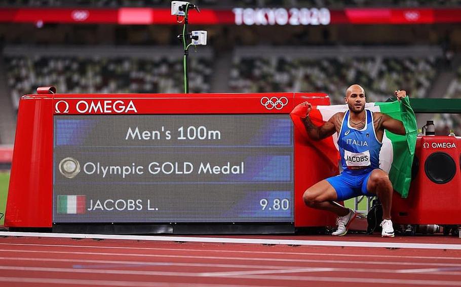 Lamont Marcell Jacobs strikes a pose after his victory in the 100 meters at the Olympics in Tokyo on Aug. 1, 2021.