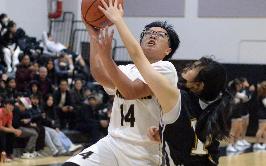 Humphreys' Stephanie Gabriel goes up for a shot against Taejon Christian during Wednesday's Korea girls basketball game. The Blackhawks won 29-28.