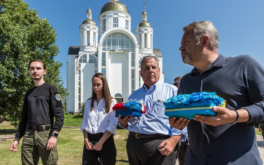 Chris Christie talks to the mayor of Bucha, Anatoly Fedoruk, near the Church of the St. Andrew and All Saints in Bucha on Friday, Aug. 4, 2023, near a mass burial site of civilians killed by Russian invaders. 