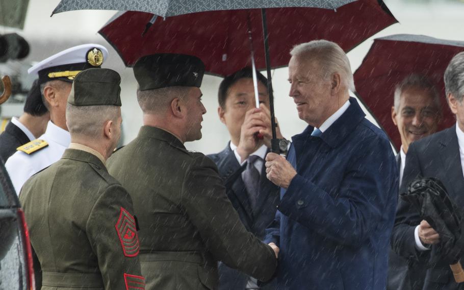 President Joe Biden chats with Col. Richard Rusnok, commander of Marine Corps Air Station Iwakuni, after arriving at the base in Japan, Thursday, May 18, 2023.