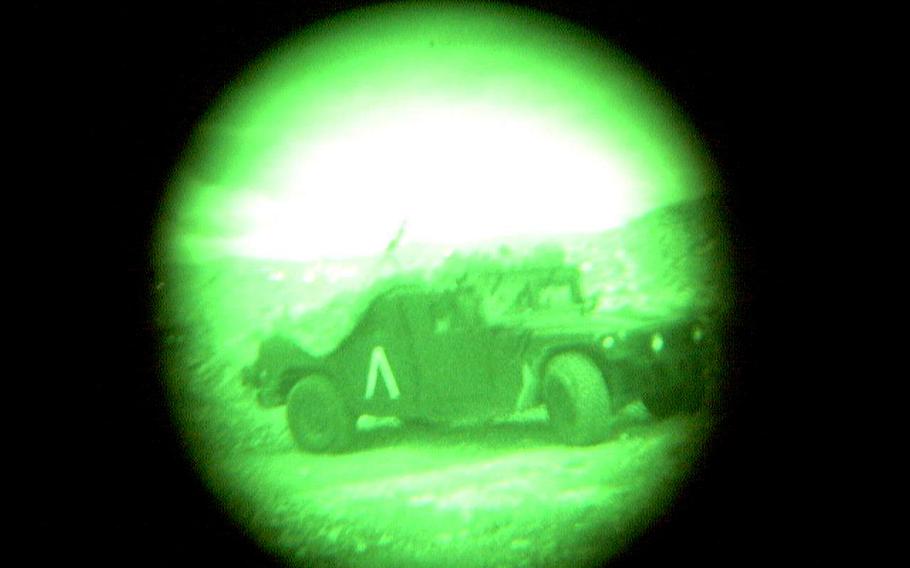 Illuminated with the same type of night vision goggles used by U.S. forces, troops in a 1st Infantry Division humvee keep watch over the Yugoslav border region in the early morning of March 30, 1999, as NATO bombers could be heard overhead beginning their strikes into Kosovo.
