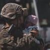A U.S. Marine calms an infant at the international airport in Kabul, Afghanistan, on Aug. 28, 2021.The upcoming one-year anniversary of the U.S. withdrawal from Afghanistan could induce moral injury resulting from trauma about the outcome of the 20-year-long war.
