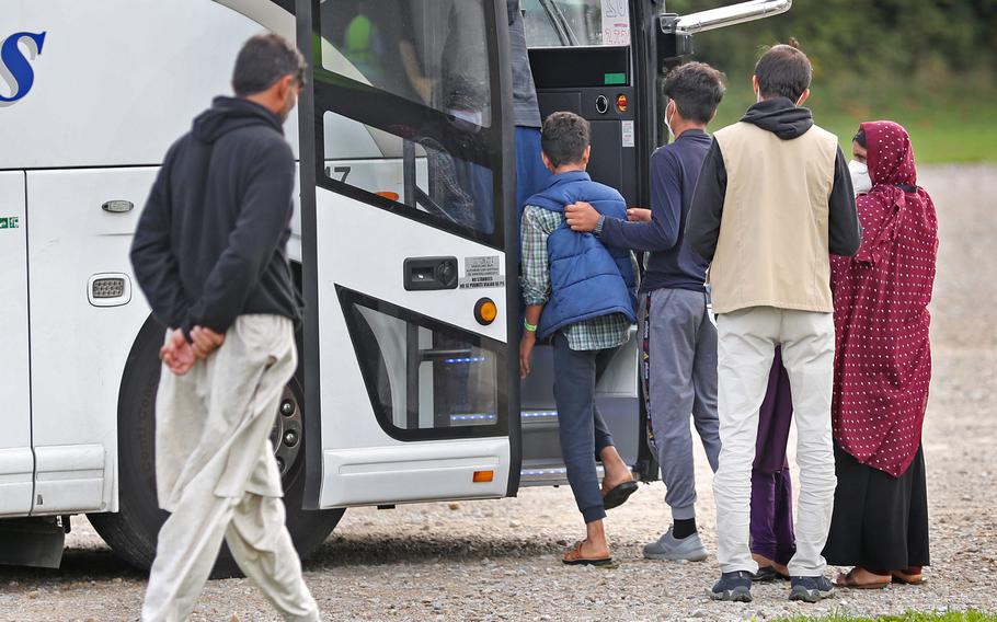 Operation Allies Welcome evacuees get on a bus to take them back to their communities Thursday, Oct. 14, 2021 at Camp Atterbury in Edinburgh, Ind.