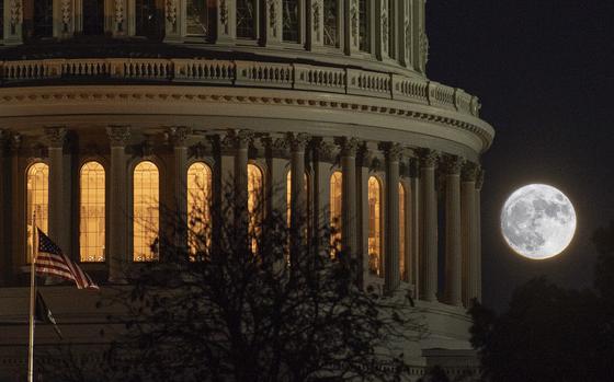 With the U.S. Capitol in the foreground, the full moon rises over Washington, D.C., on Halloween.