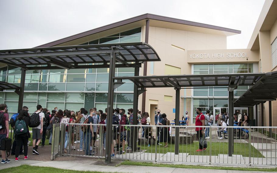 Students wait outside Yokota High School on Monday, Aug. 23, 2021, the first day of classes at the school at Tokyo's Yokota Air Base.