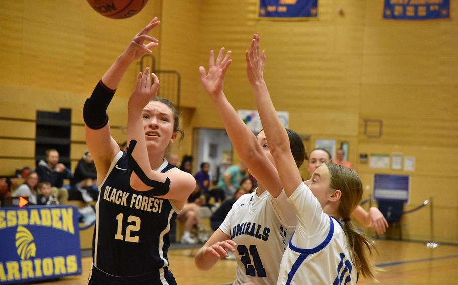 Black Forest Academy’s Emma Gibson puts up a shot against determined resistence from Rota defenders Allie DeMerritt and Sophia Dickkut in the Admirals’ opening day victory at the DODEA European Division II Basketball Championships on Wednesday, Feb.14, 2024, in Wiesbaden, Germany.