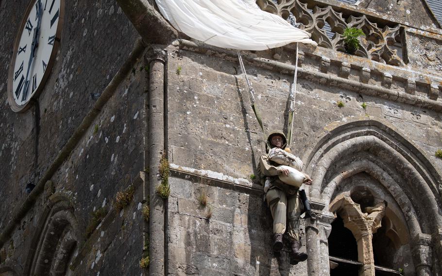 An effigy of Pvt. John Steele hangs from the village church in Sainte-Mère-Église, France, June 3, 2024. 