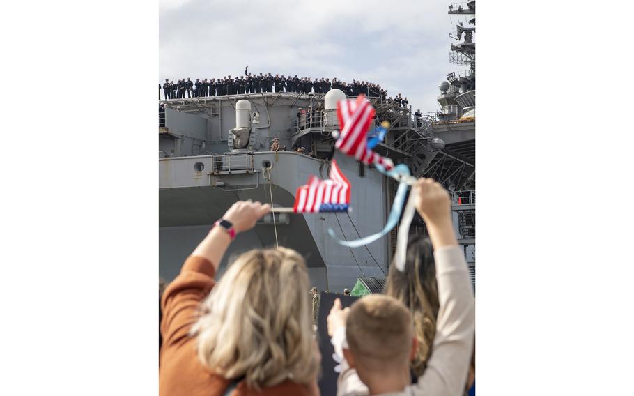 Sailors assigned to amphibious assault carrier USS Tripoli (LHA 7) celebrate their warm welcome home by friends and families, Tuesday, Nov. 29, 2022.
