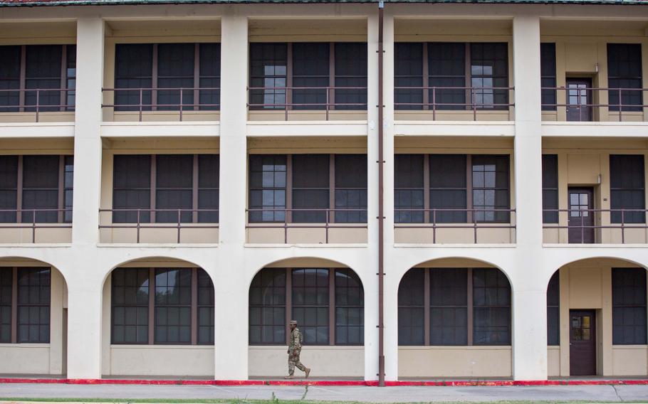 A soldier walks through the barracks at Fort Benning, Ga., where Pvt. Felix Hall lived before his death in 1941. 