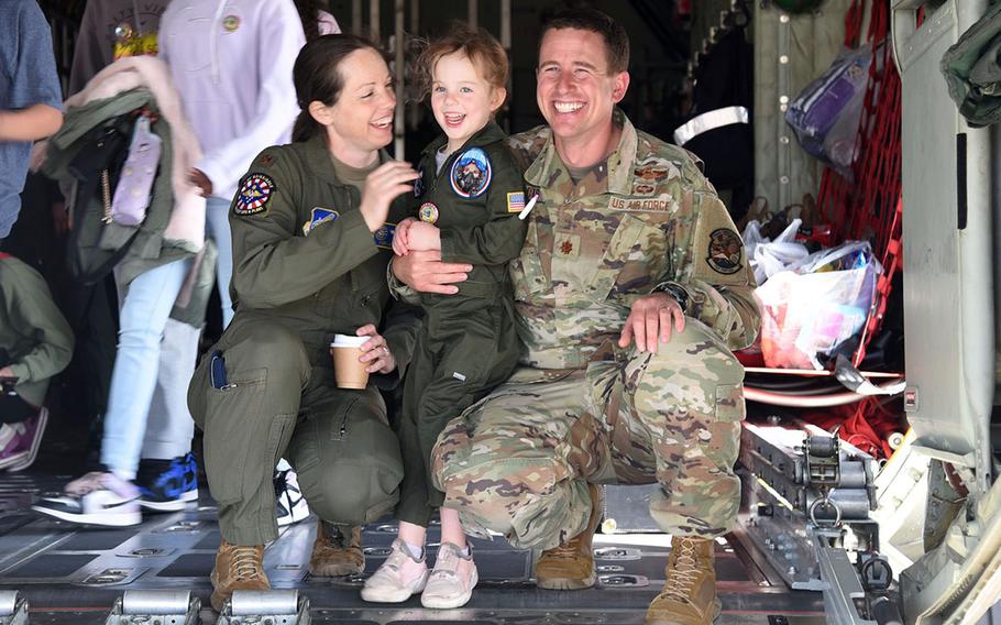 Maj. Keri Morris, of 5th Air Force, and Maj. Andrew Morris, of the 36th Airlift Squadron, pose with their daughter, Audrey, during the second-annual Fly Girls event at Yokota Air Base, Japan, Wednesday, March 8, 2023. 