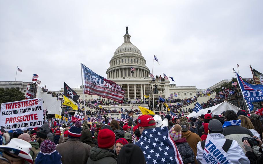 Insurrectionists loyal to President Donald Trump storm the U.S. Capitol in Washington on Jan. 6, 2021. On Tuesday, Jan. 17, 2023, Hatchet Speed, a Navy reservist who is charged with storming the Capitol on Jan. 6, went back to trial in Virginia on separate charges that he illegally bought silencers — and talked about using them against Jewish people and others he considered to be enemies.